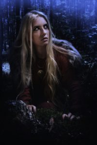 Scandinavian girl in the night forest